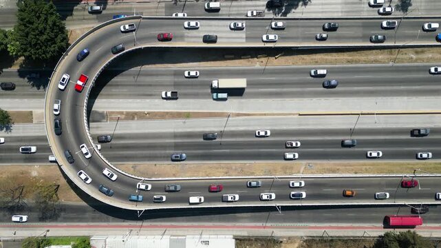 Aerial drone view capturing a busy Zapopan highway interchange with multiple lanes of moving traffic, highlighting urban transportation infrastructure.