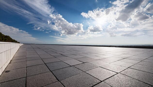 empty paved expanse under a partly cloudy sky