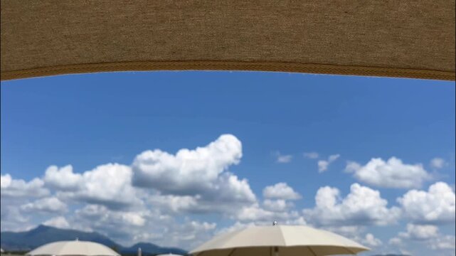 Beach with rows of colorful umbrellas and sunbeds on traditional beach in Viareggio, Lucca, Tuscany Italy.