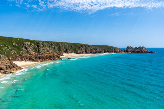 Coastal landscape with turquoise water and rocky cliffs in Cornwall, UK.