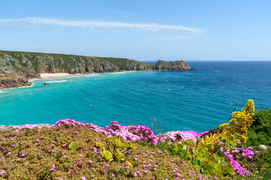 Coastal landscape with turquoise water and rocky cliffs in Cornwall, UK.