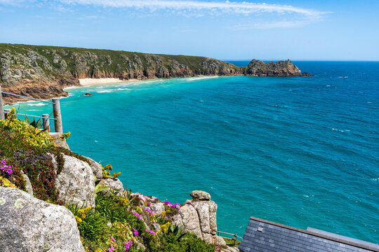 Coastal landscape with turquoise water and rocky cliffs in Cornwall, UK.