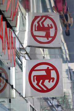 Cologne, Germany July 15 2026: The red centaur logo of Rossmann drugstore with a distorted reflection on a polished metallic ceiling in Cologne, Germany.