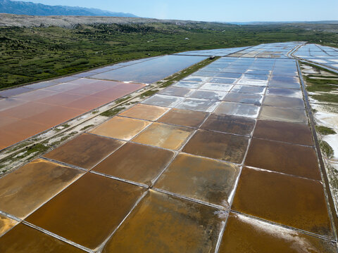 Aerial drone view of Pag Island salt pans or Solana Pag, Croatia. Colorful Salt Evaporation Ponds and Adriatic Landscape