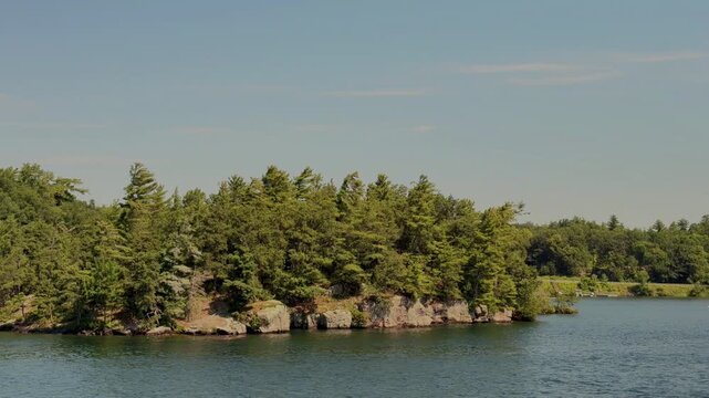 Forested Rocky Island Surrounded by Calm Summer Water