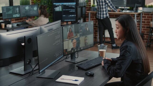Software development team reviews a coding project during an online meeting, using video call communication to coordinate software work and delivery deadlines