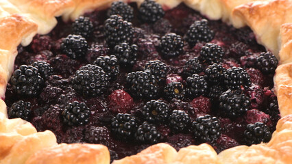 Close-up of Fresh Blackberry Galette with Golden Puff Pastry © homydesign
