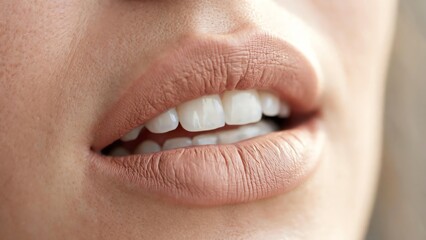 Obraz premium Close-up of woman's lips with natural makeup and healthy teeth