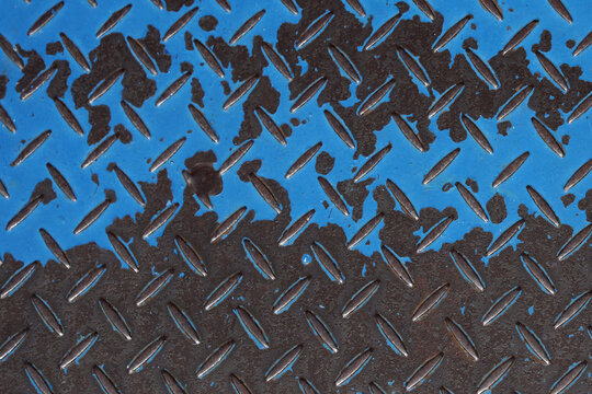 Patterned Metal Surface With Blue Paint And Dark Rust Stains