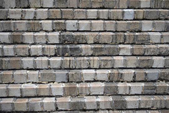 Close up of weathered brick wall with varying neutral tones in horizontal pattern