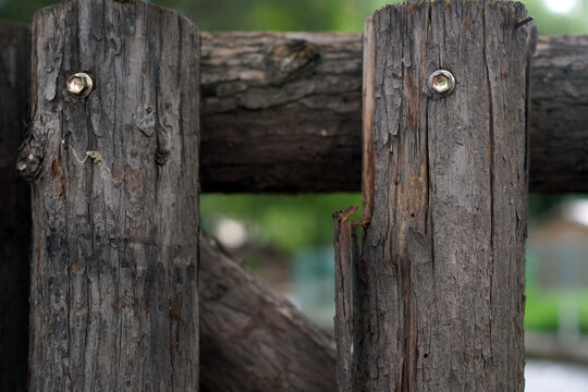 Close Up of Weathered Wooden Fence with Metal Screws
