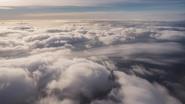 aerial cloudscape above clouds at sunrise with sunlit horizon sky