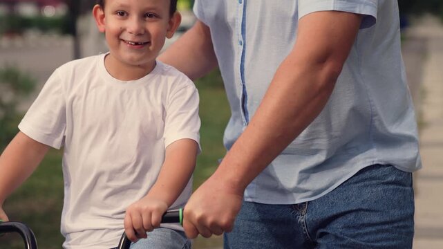 man teach child kid son boy ride bike park, happy family, happy smile face, wind children's hair, concept father child play entertainment keep balance training, adrenaline horse riding, boy son happy