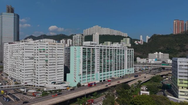 July 11 2026 Tall manufacturing factories line dense urban city streets.