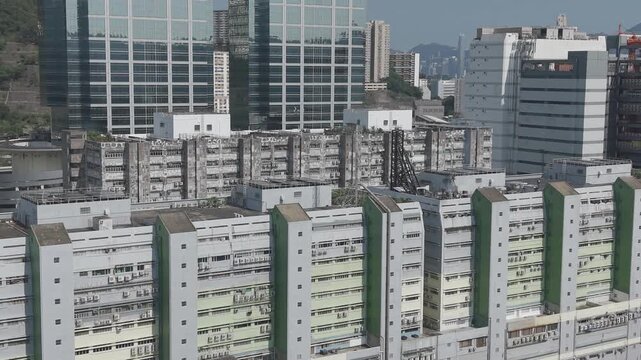 July 11 2026 Tall manufacturing factories line dense urban city streets.