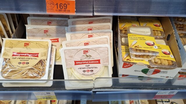 Chechil string cheese and gourmet cream cheese snacks in supermarket refrigerator
