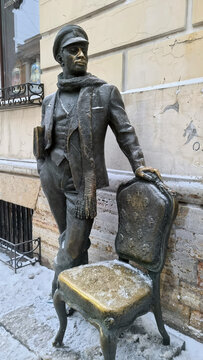 Bronze Ostap Bender Statue with Golden Chair in Winter Saint Petersburg