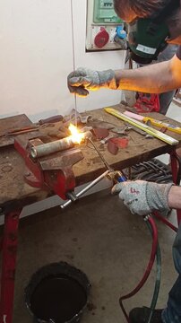 Trainee using gas torch for metal welding