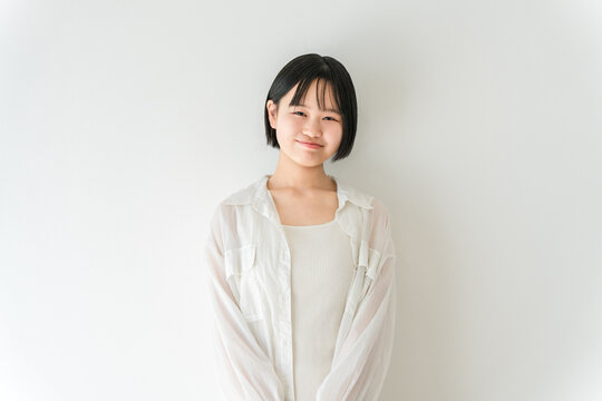 A smiling high school student, a middle school girl in casual clothes, and a woman in front of a white background.