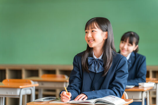 Middle school, elementary school, and high school students diligently studying in school classrooms and cram schools.
