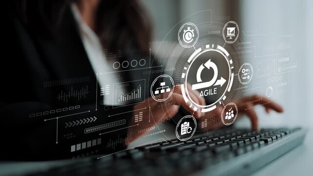 Agile Project Management Concept with Visual Icons and Metrics Displayed on a Digital Screen While a Professional Uses a Keyboard. Entropy.