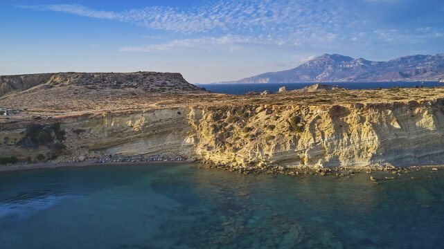 Rocky coast with bright sunshine and blue sky by the sea, drone shot, evening light, Paralia Agios Theodoros, Agios Theodoros Beach, southwest coast, Karpathos, Dodecanese, Greek Islands, Greece