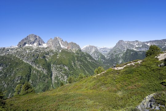 Mountaineer on hiking trail to Aiguillette des Posettes, mountain panorama with summit Aiguille de Mesure and Aiguille de Chamois, Mont Bues and Pointe de la Terasse, Chablais Alps, Chamonix, Haute-Savoie, France