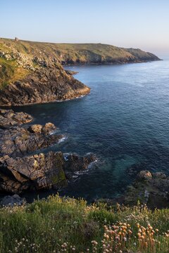 Coastal landscape at Botallack Mine, also known as Crown Mine. The ruins of Wheal Edward in the background. Evening, golden hour. Botallack, Penzance, Cornwall, England, Great Britain