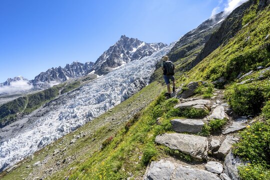 Hiking on the trail to La Jonction, Glacier des Bossons, behind the summit of the Aiguille du Midi, Chamonix, Haute-Savoie, France
