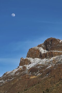 Moon over a snowy mountain peak under clear blue sky, Teide, Parque Nacional del Teide, Teide National Park, volcano, volcanism, UNESCO World Heritage Site, Tenerife, Canary Islands, Spain