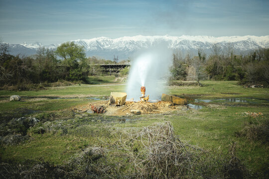 Broken water pipe, in the background Lesser Caucasus, Abkhazia, Georgia