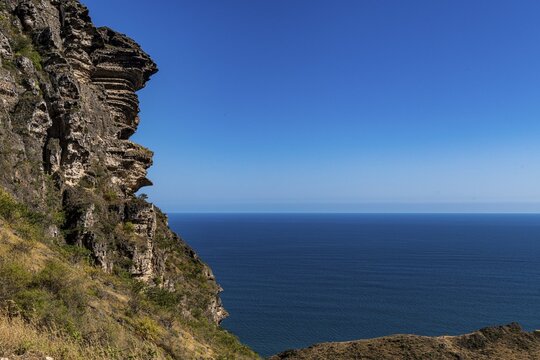 Rugged mountains over Fazayah beach, Salalah, Oman