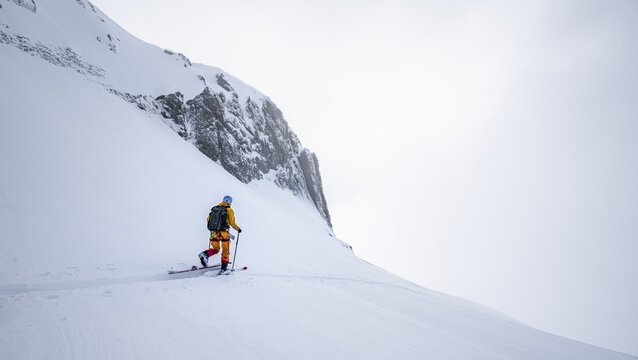 Lone ski tourer in snowy mountain landscape in the morning light, ascent to the Wildhorn, cloudy mood, high tour, Bernese Alps, Bernese Oberland, Switzerland