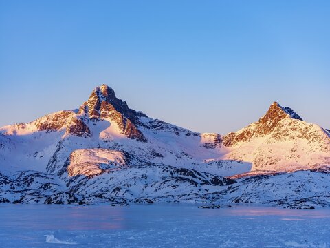 Snowy mountains above the frozen Kong Oscar Fjord, Tasiilaq, Ammassalik Island, Kommuneqarfik Sermersooq, East Greenland, Greenland