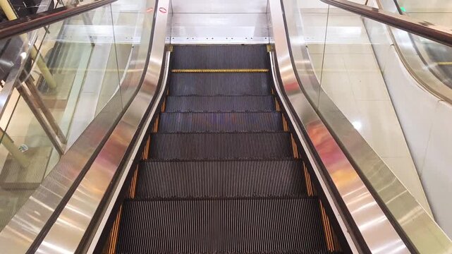 Moving down on an empty escalator inside a modern building