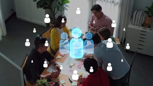 A diverse group of professionals collaborates in a modern office, leveraging digital technology for effective communication and innovative teamwork strategies. Raster