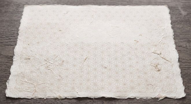 Luxury Japanese washi paper background with subtle Asanoha geometric pattern