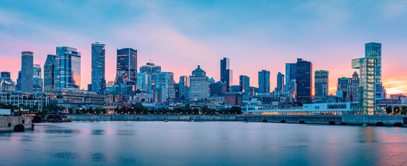 Panoramic view of the Montreal skyline at dusk from the Old Port, downtown skyscrapers along the Saint Lawrence River waterfront, Quebec, Canada © Shawn M. Kent