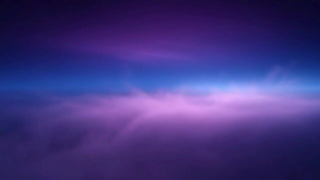 Aerial view of soft purple and blue clouds at twilight or dawn.