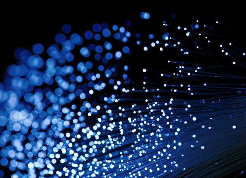 Glowing blue fibers illuminated against a dark background