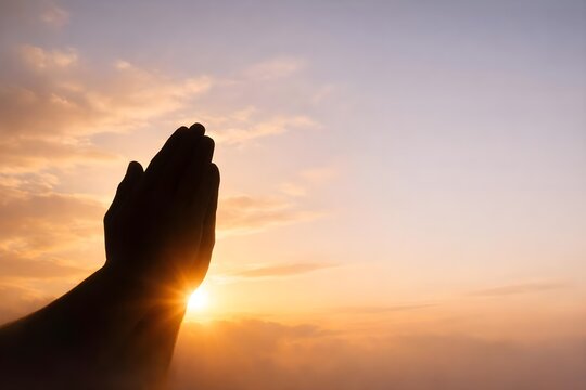 praying hands at sunrise expressing hope faith and spiritual devotion
