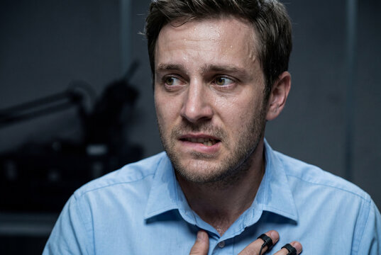 Sweating nervous man taking polygraph lie detector test