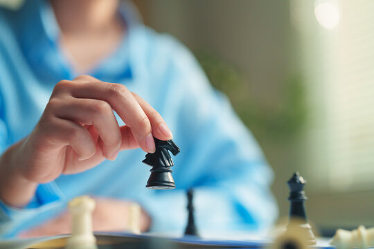 Strategist executing a critical move on a chessboard, corporate strategy development, problem-solving, competitive advantage, and future business growth