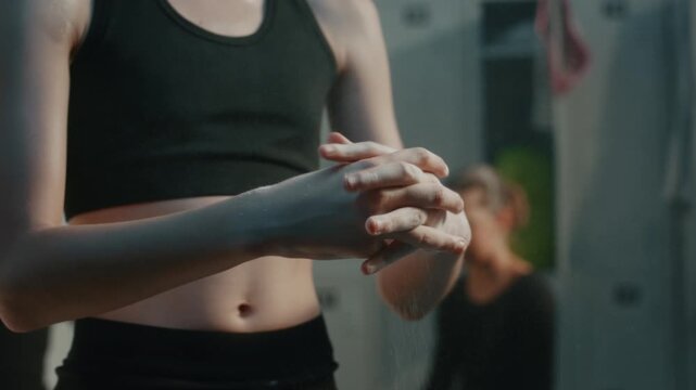 Teenage Rhythmic Gymnast Preparing For Difficult Routine. Girl Applies Magnesium Powder to Hands to Prevent Sweat and Slipping. Mental Conditioning and Backstage Rituals Behind Elite Sport Successes.