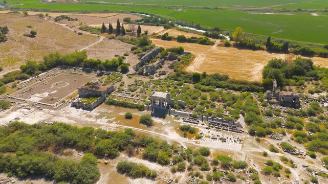 Balat, Turkey. Aerial view of ancient Miletus ruins, stone foundations and orthogonal grid plan amid green and golden agricultural fields under bright summer sun. Aerial View, MasterShots, Rocket