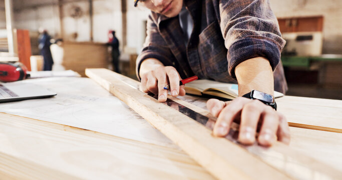 Carpentry, measure and hands in workshop with wood for manufacturing, productivity and production. Man, ruler and warehouse with pencil for custom or handmade woodworking, workbench and timber