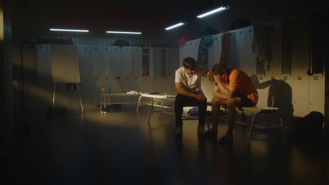 Coach Reassures Teenage Football Player Following Setback, Creating Calm and Supportive Atmosphere in Empty Team Locker Room. Mentorship, Character Building, and Emotional Recovery Beyond Competition.