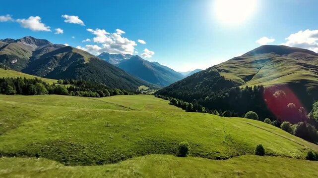 Aerial drone view over green mountain alpine meadows on a sunny day