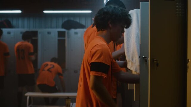 Young Soccer Teammates Enjoy Lighthearted Moments in Locker Room after Finishing Practice, Changing Clothes, Teasing One Another. Genuine Emotions, Friendship, and Everyday Life inside Football Club.