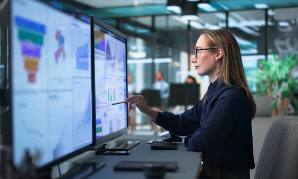 Young Financial Analyst Using Computer